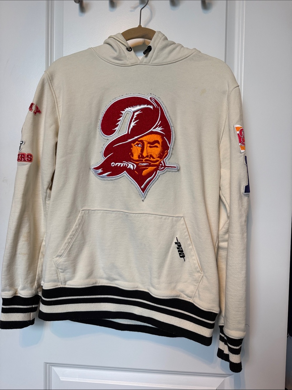 Cream Hoodie with Red Graphic Pirate Logo
